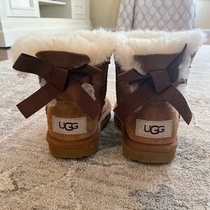UGG Mini Bailey Bow Bootie in “Chestnut”